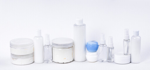 Plastic containers with cream without labels for brand advertising on a white background. 