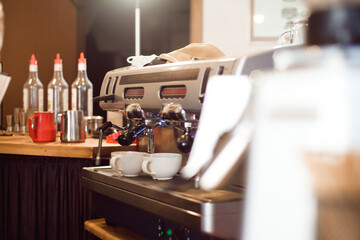 Barista make coffee latte art with espresso machine in cafe.