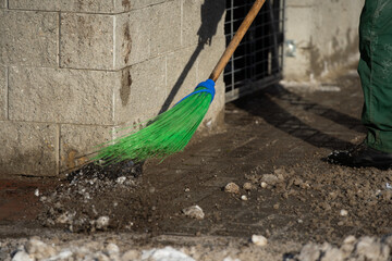 A close-up view as a worker sweeps the pavement out of loose snow