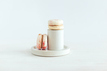 Tasty french macaroons on a white wooden background. Pastel colors.