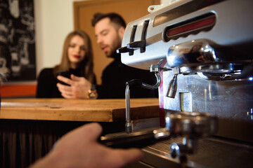 Female starting her day on a new job as a barista. Working in a cafe.