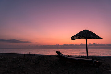A beach in south Turkey with sunbeds and an umbrella, taken right before sunrise