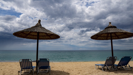 beach with umbrella and chairs