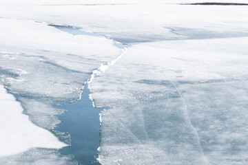 An ice floe breaks ups in the spring thaw revealing the frigid water below.