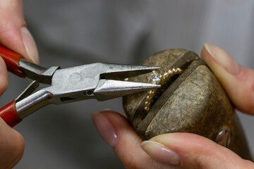 Profession jeweler. Hands of an jeweller . Craft jewelry making. Handwork . Close up.