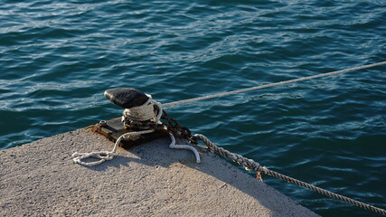 black mooring pylon with white rope