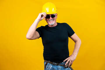 worker with helmet and sunglasses isolated on yellow background