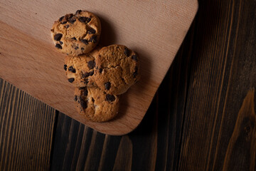 Chocolate chip cookies on the table. Cookies on a wooden table with burlap. Homemade cookies. Country style. With a place for your text. 