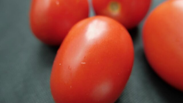 Close-up of fresh tomatoes on a dark blue table