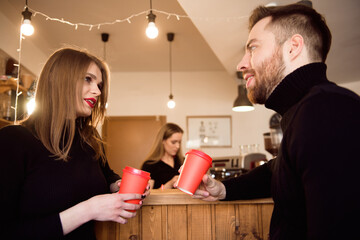 Young attractive couple on date in coffee shop.