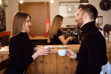 Beautiful Woman And Handsome Man Drinking Coffee While Spending Time In Coffee Shop.