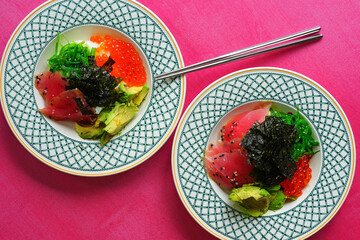 Asian green rice bowl with smoked Ahi tuna slices, salmon roe, cucumber, and avocado