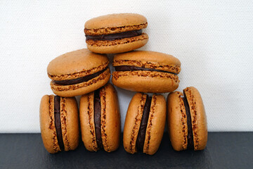 Homemade Chocolate cocoa macaron cookies filled with chocolate hazelnut ganache