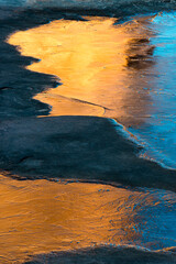 USA, Utah. Abstract design of the Organ reflected in an ice covered pool, Arches National Park.