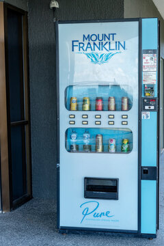 Mackay, Queensland, Australia - March 2021:  Bottled water and soft drinks for sale from coin in slot machine