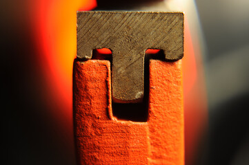 Macro view of the adjustment mechanism on a pipe wrench, highlighting the interlocking metal...