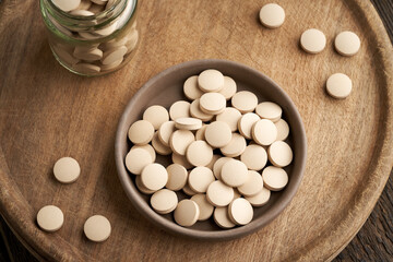 Brewer's yeast tablets in a bowl, top view