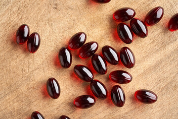 Krill oil pills on a wooden table