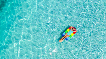 Aerial view. Beautiful woman wearing blue bikini. Happy and enjoying beach relaxing joyful in summer by tropical blue water.A sexy young girl.Holiday person.Amazing sea nature background.