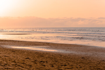 sunset with surfers in the sea in spring. Spain. holidays