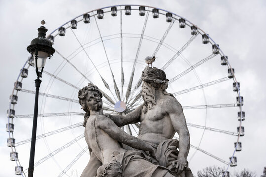 View of statue and Grande Roue ferris wheel, Paris, France
