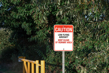 Fototapeta premium View of sign Caution Low Flying Aircraft at local airport in Courtenay, Canada.