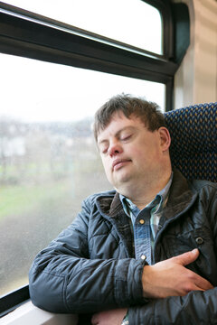 Man with down syndrome sleeping on train