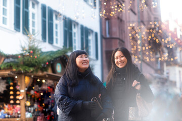 Mother and daughter window shopping at Christmas market, Freiburg, Baden-Wurttemberg, Germany