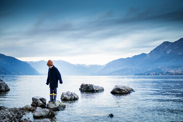 Boy exploring around lakeside, Onno, Lombardy, Italy