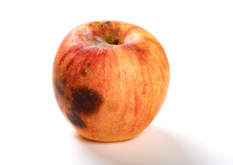 side view overripe apple on a white background