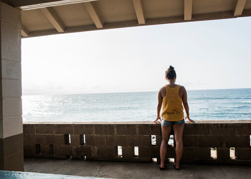 Woman looking at sea from balcony, Hookipa Beach, Maui, Hawaii