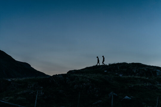 Boys playing on hilltop, Snowdonia, Llanberis, Gwynedd, UK