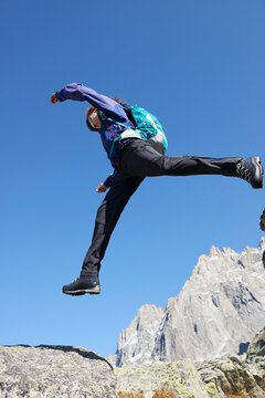 Mountain climber jumping, Chamonix, Rhone-Alps, France