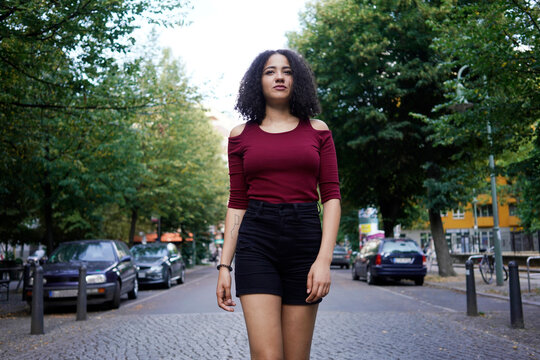 Young woman in middle of street, Berlin, Germany