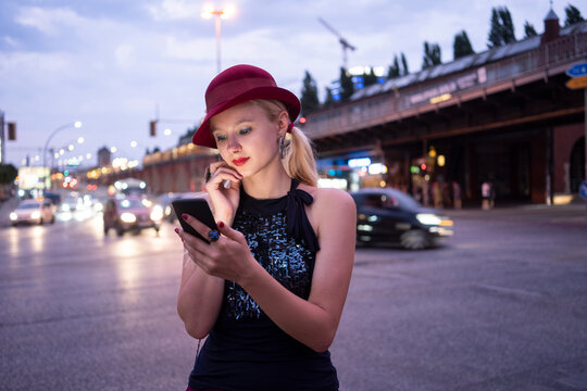 Hipster woman texting in street, Berlin, Germany