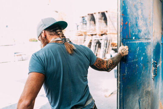 Man closing warehouse door