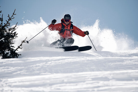Male skier swerve skiing down mountain, Alpe-d'Huez, Rhone-Alpes, France