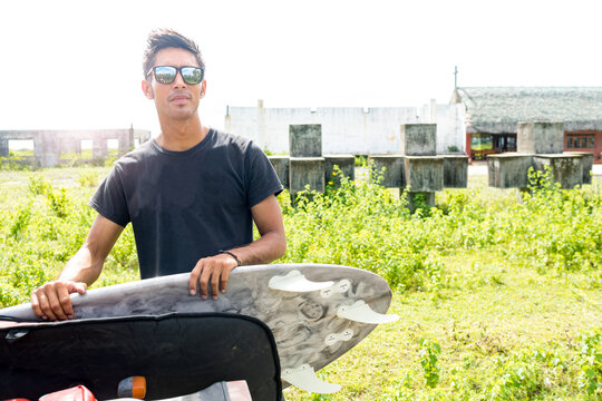 Man with surfboard, Abulug, Cagayan, Philippines