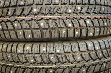 Studded car tires lie on top of each other (winter).