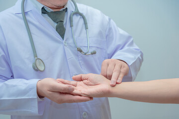 Doctor shook the patient  hand to check the heart rate