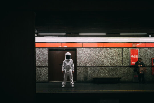 Astronaut waiting on train platform