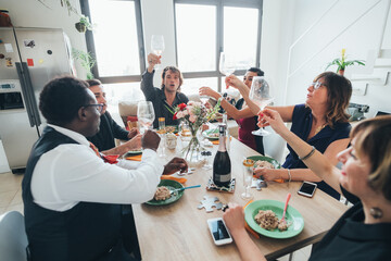 Businessmen and businesswomen celebrating at lunch party in loft office
