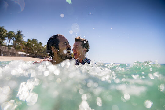 Couple splashing in sea, Pagudpud, Ilocos Norte, Philippines