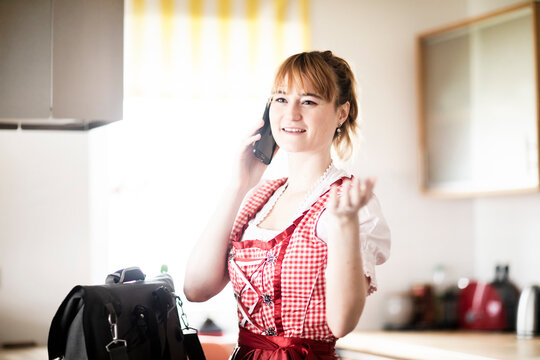 Woman using smartphone in kitchen