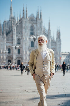 Senior businessman exploring city, Milan Cathedral in background, Milano, Lombardia, Italy