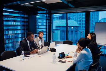 Businessmen and women having discussion over conference table meeting