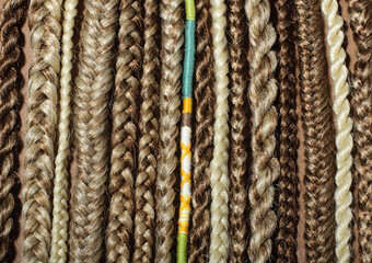 Close-up of afro pigtails braids, Kanekalon technique with multi-colored threads and dreadlocks,...