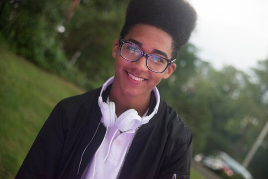 Teenage Boy With Afro Flat Top Hairstyle In Park , Portrait