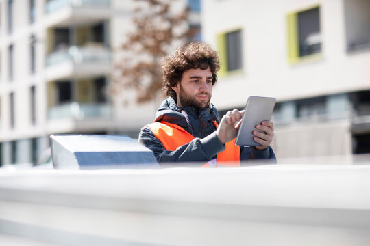 Man using digital tablet on street