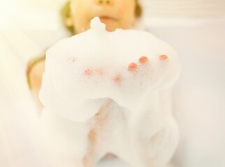 bath foam. baby hands in bubble bath, baby washing in bubble bath